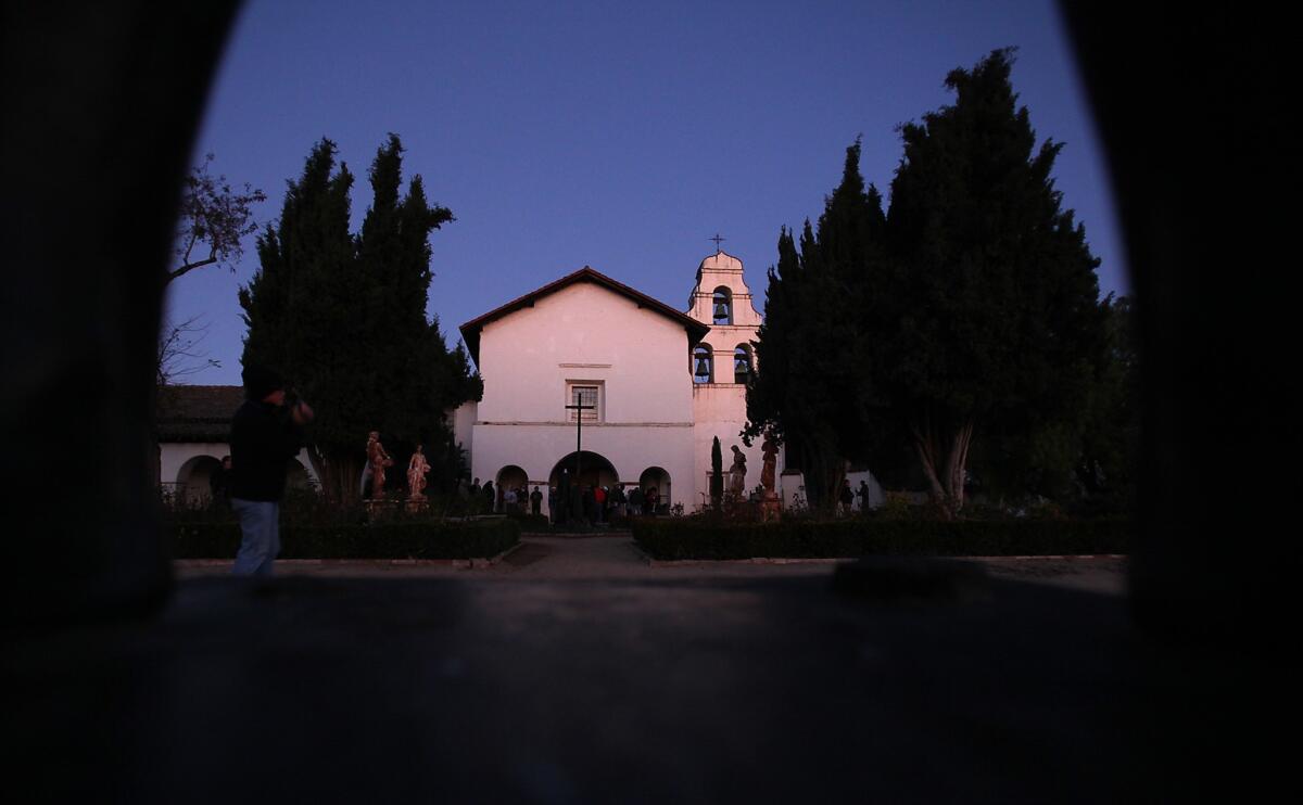 On December 21, 2011, dawn light shines on Mission San Juan Bautista, where visitors and parishioners gathered for the winter solstice illumination.