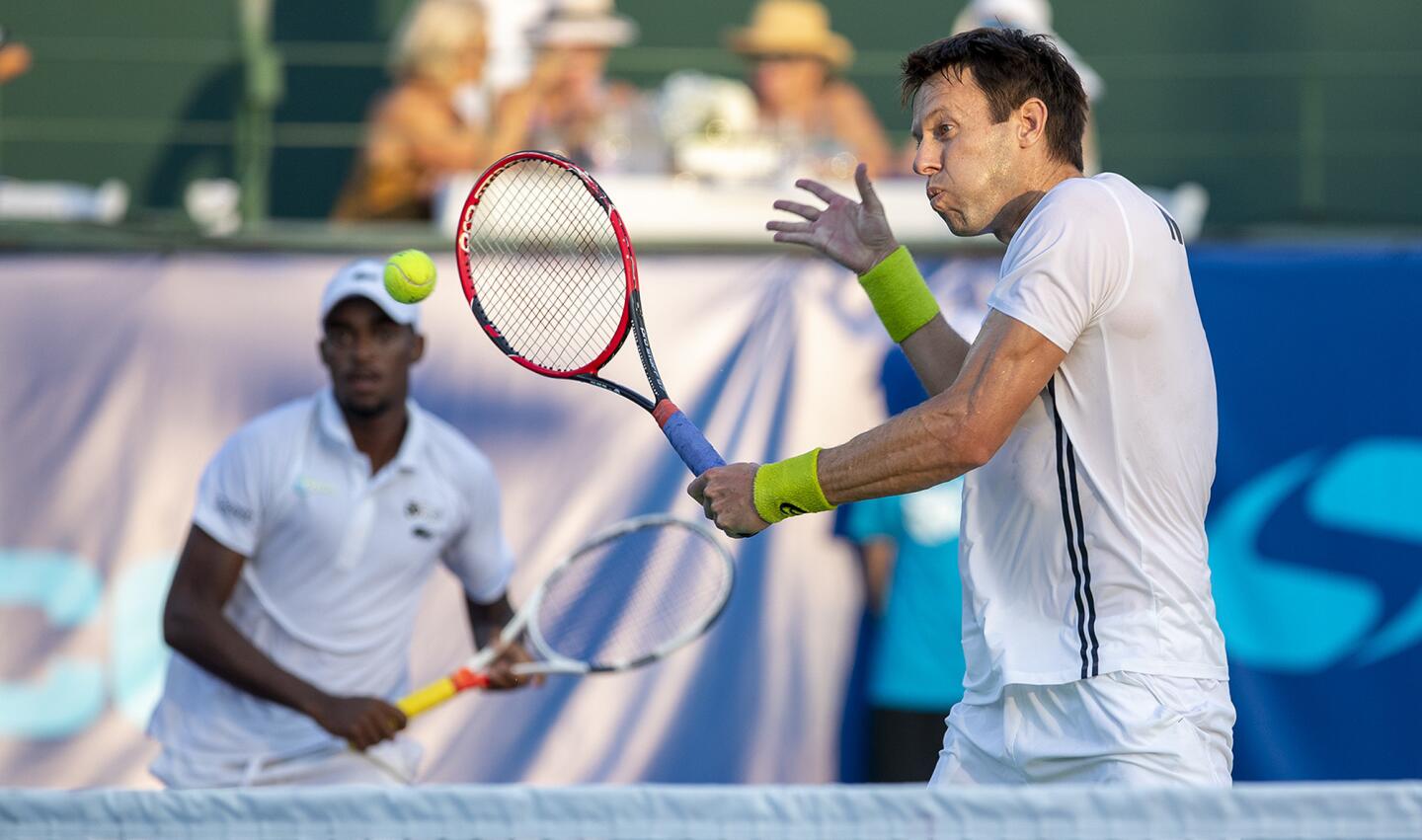 Orange County Breakers' Daniel Nestor returns a shot during a mens' doubles match against the Washington Kastles during a World Team Tennis match at the Palisades Tennis Club on Thursday, August 2.