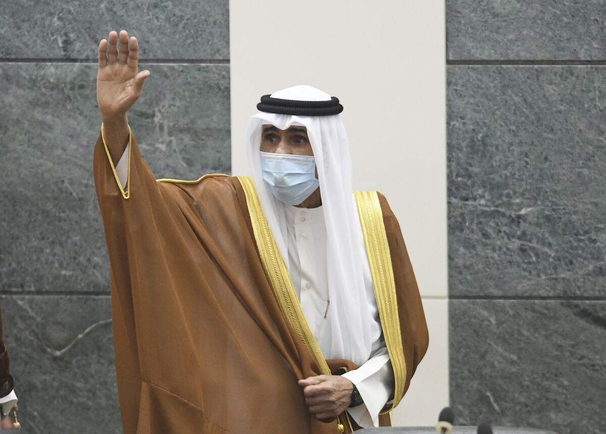 The new Emir of Kuwait Sheikh Nawaf Al Ahmad Al Sabah, waves after he performed the constitutional oath at the Kuwaiti National Assembly in Kuwait, Wednesday, Sept. 30, 2020. Kuwait's Sheikh Nawaf Al Ahmad Al Sabah was sworn in Wednesday as the ruling emir of the tiny oil-rich country, propelled to power by the death of his half-brother after a long career in the security services. (AP Photo/Jaber Abdulkhaleg)
