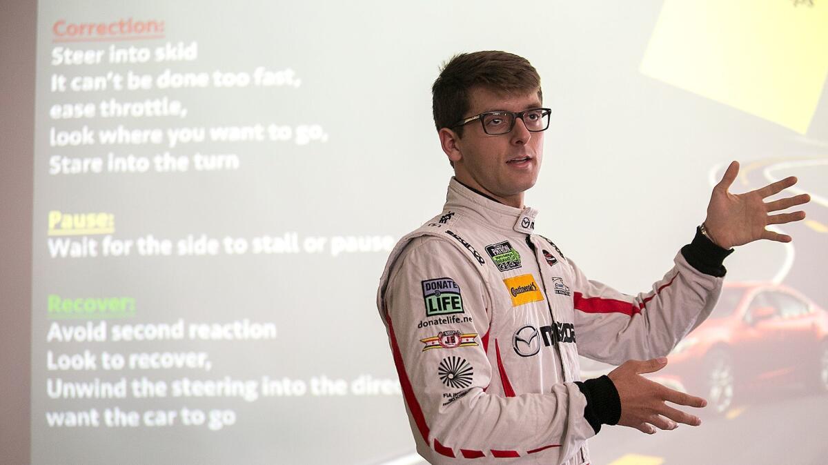 Mazda Motorsports pro driver and Cal State Fullerton student Kenton Koch speaks to a group of students at Fountain Valley High School on behalf of Project Yellow Light on Tuesday.