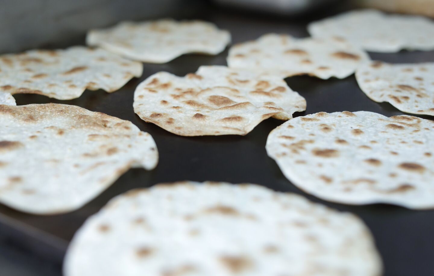 Handmade flour tortillas get grilled for vampiros at the family-owned taco truck Asadero Chikali.