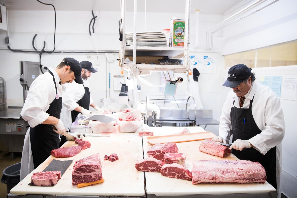 Butchers Tristan Gallo, left, Greg Stoffel and Mike Carroll at work at Corti Brothers.