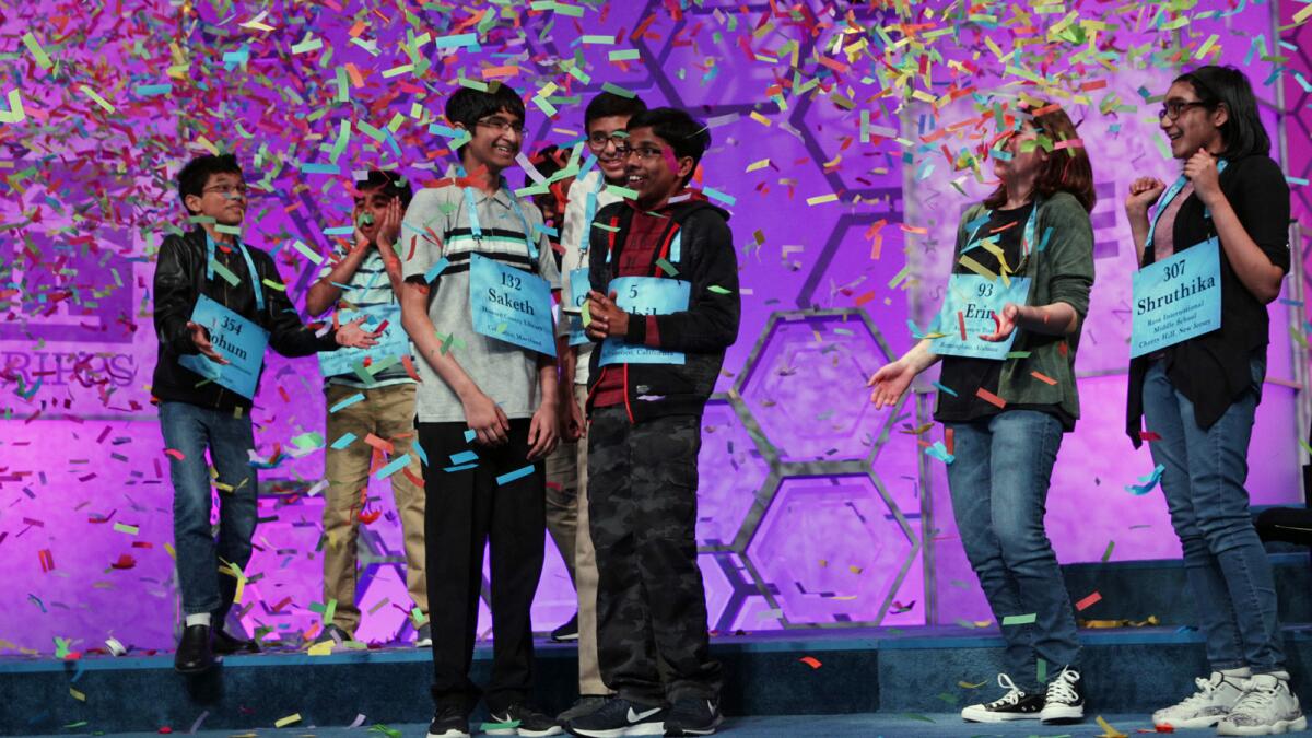 The co-champions celebrate after 20 rounds of competition at the Scripps National Spelling Bee in National Harbor, Md.