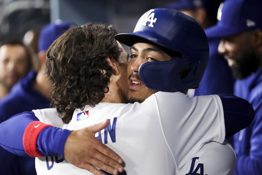 LOS ANGELES, CA - MARCH 30: Los Angeles Dodgers' Miguel Vargas, right, celebrates.