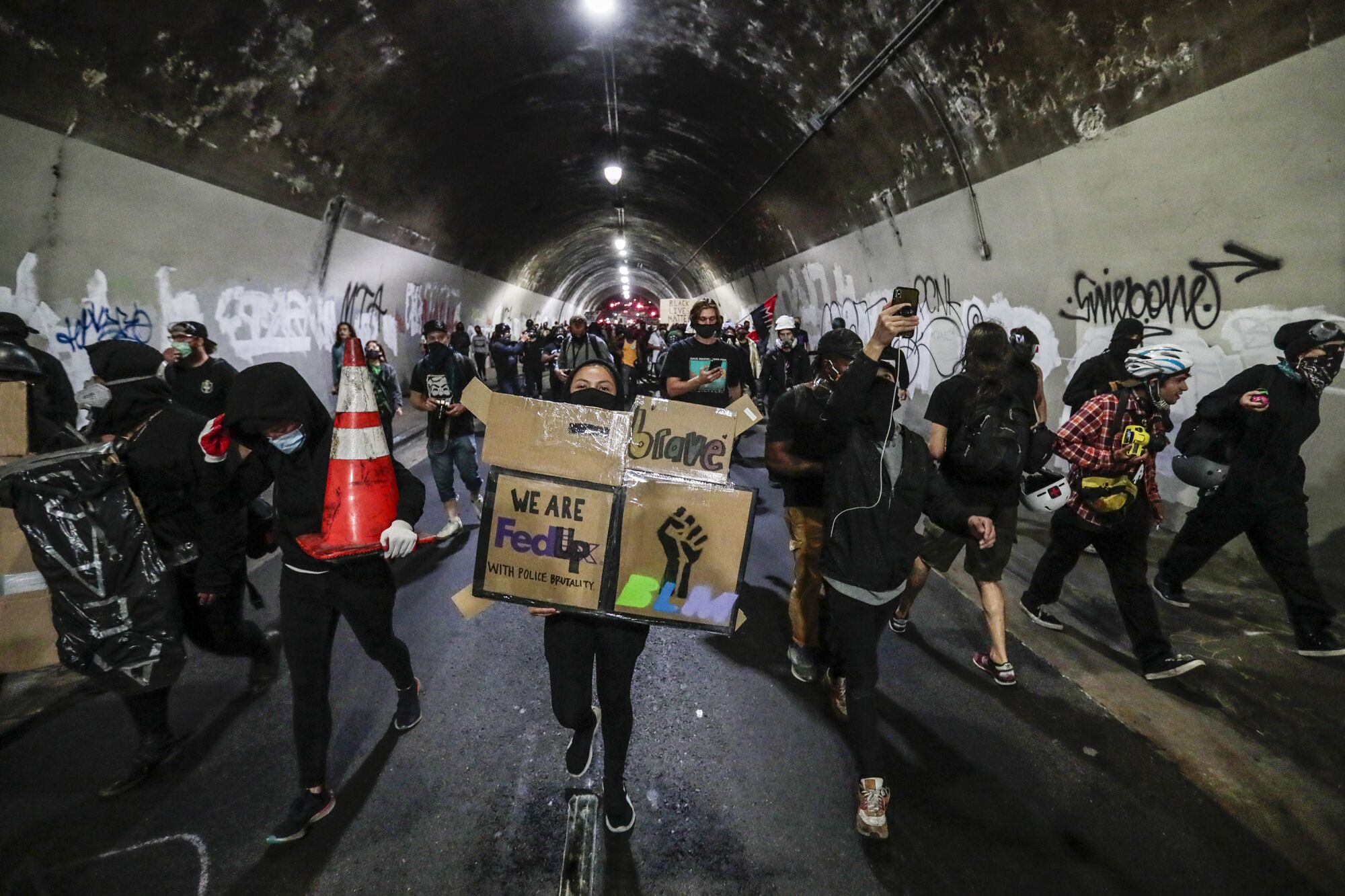 Protesters march through the 3rd Street tunnel