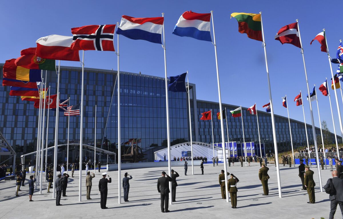 FILE - In this May 25, 2017 file photo, flags of NATO member countries flutter during a NATO summit in Brussels. The NATO military alliance and the European Union on Tuesday, Aug. 3, 2021 joined a growing chorus of international condemnation of Iran's alleged attack on a merchant ship in the Arabian Sea last week and urged Tehran to respect its international obligations. (AP Photo/Geert Vanden Wijngaert, Pool, File)
