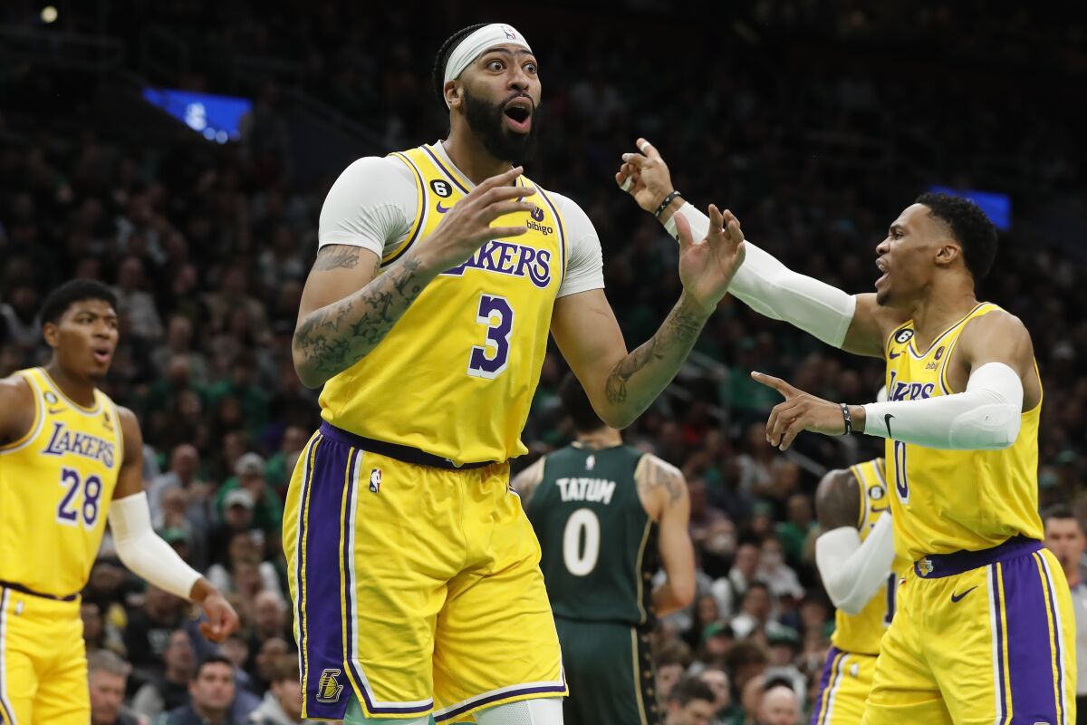 Lakers forward Anthony Davis, center, and Russell Westbrook, right, react to a call.