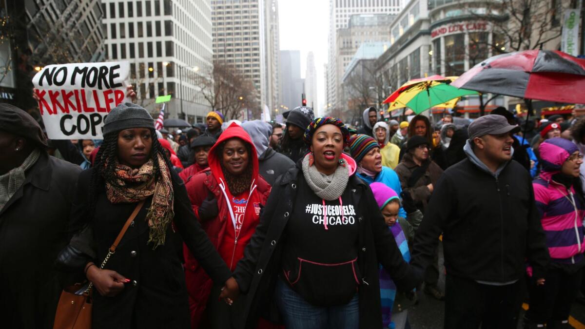 Demonstrators join a March for Justice after the release of a police video showing Chicago Officer Jason Van Dyke fatally shooting Laquan McDonald.