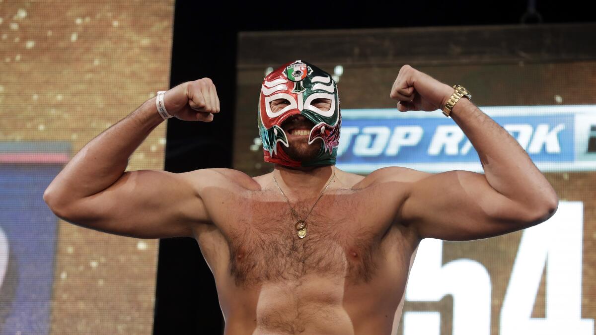 Tyson Fury poses wearing a luchador mask during the weigh-in for his fight against Otto Wallin.