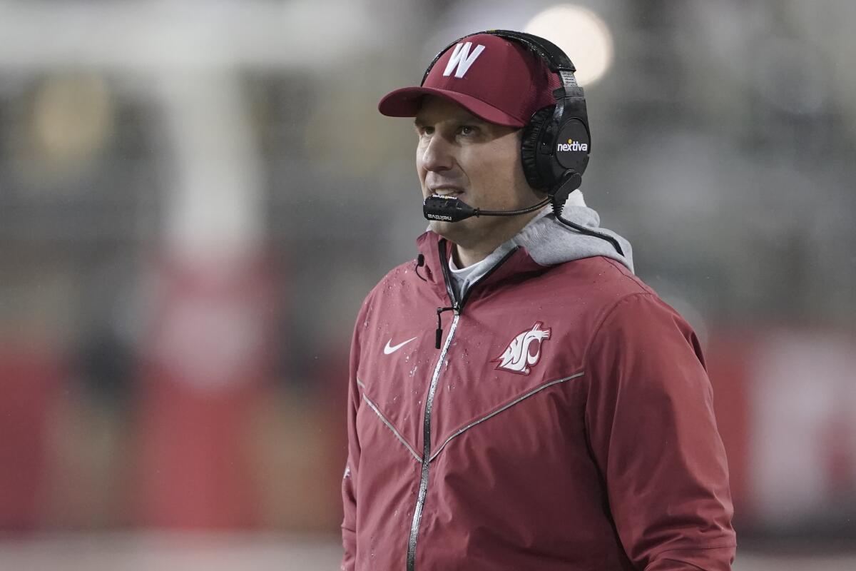 Washington State acting head coach Jake Dickert wears a headset on the sideline during a game against Arizona on Nov. 19.