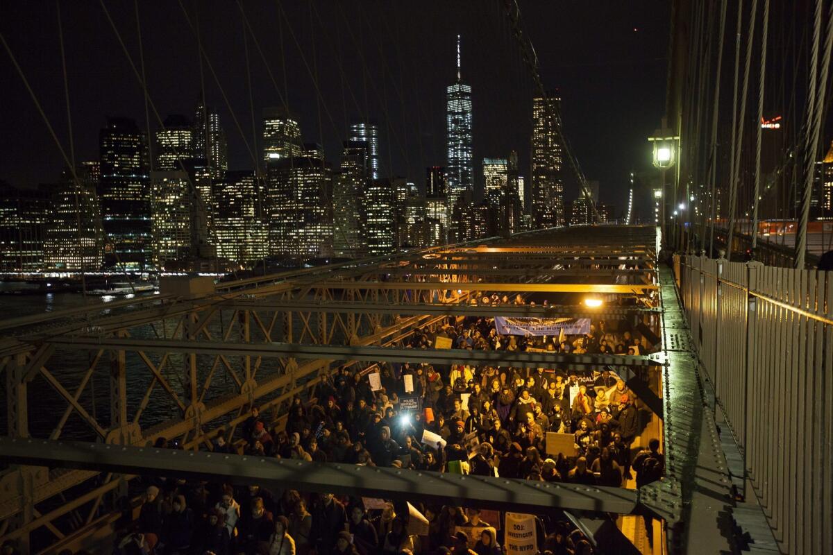 People march over the Brooklyn Bridge in protest against the decision of a grand jury not to indict a police officer involved in the death of Eric Garner, in New York, New York, USA, 04 December 2014.