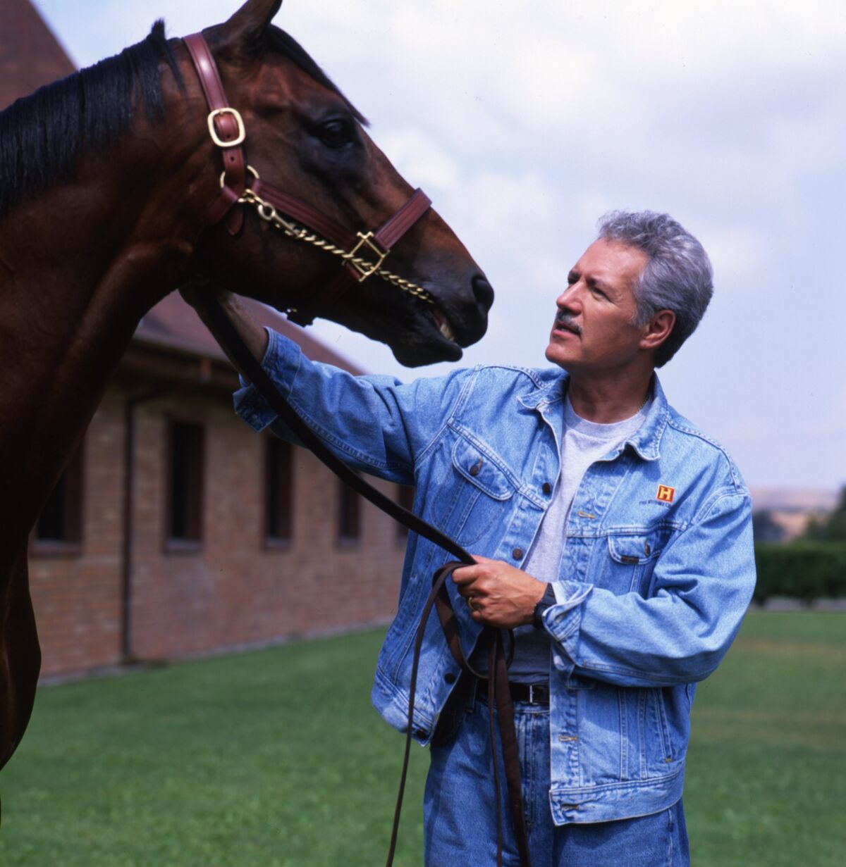 Alex Trebek with a horse. 