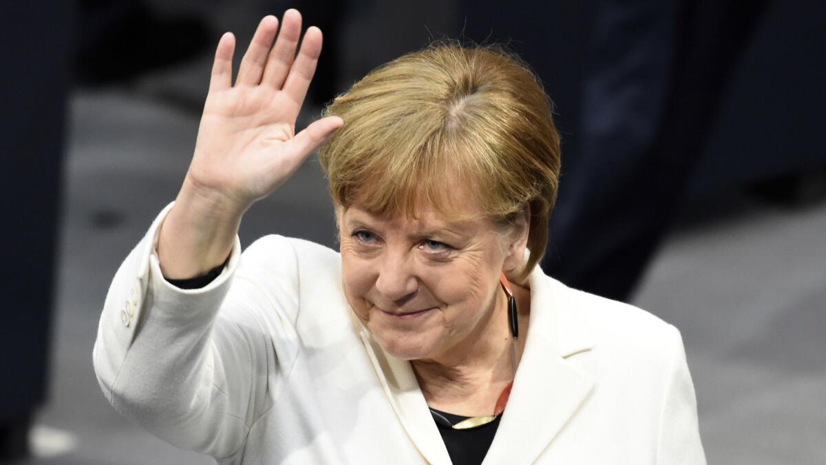 Chancellor Angela Merkel waves as Germany's Parliament Bundestag meets to elect her for a fourth term March 14 in Berlin.