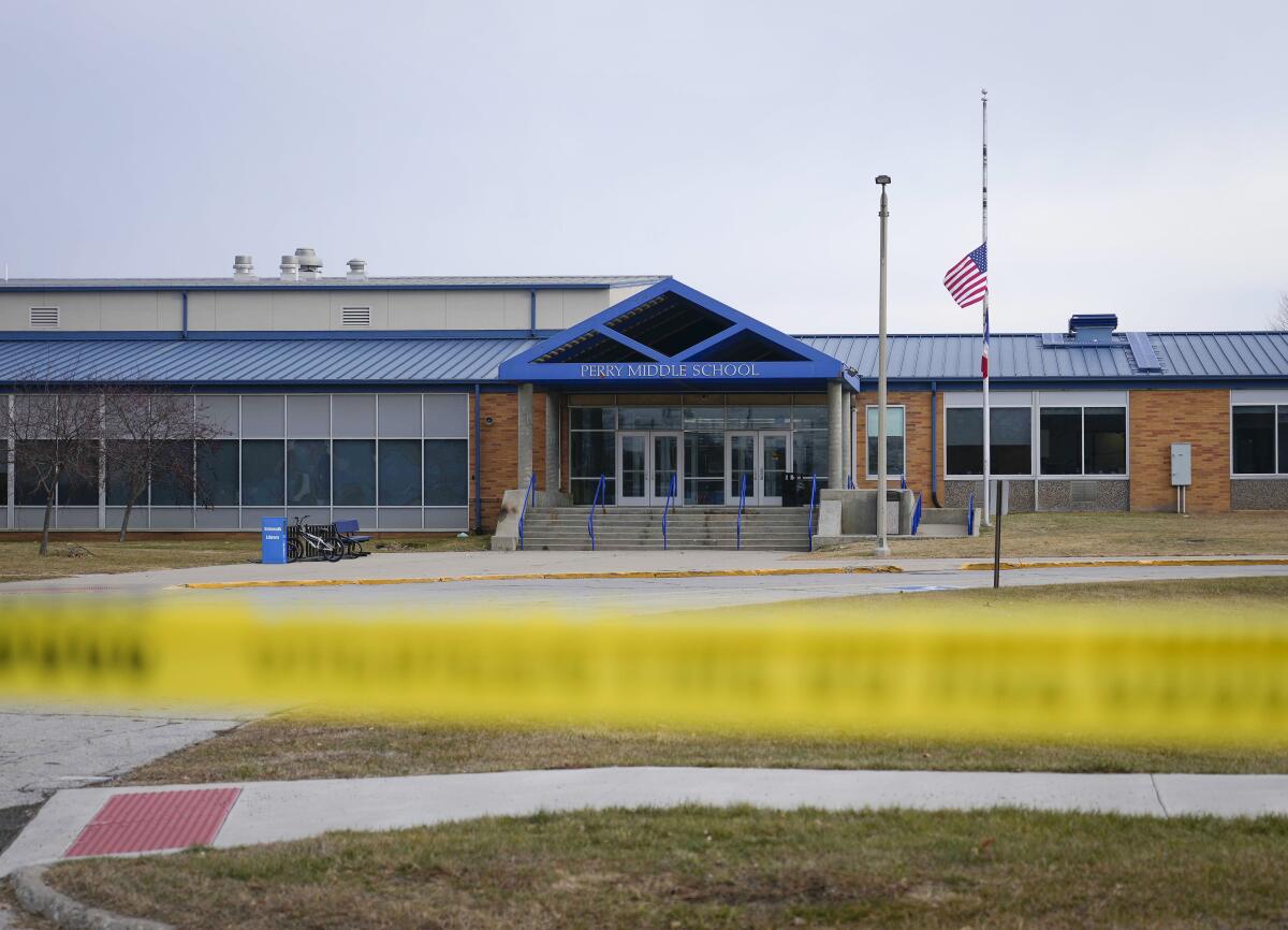 Police tape in front of entrance to Iowa school