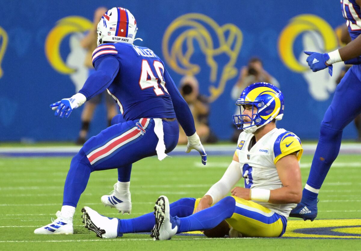 Rams quarterback Matthew Stafford watches from the ground as Bills' Von Miller celebrates a sack.