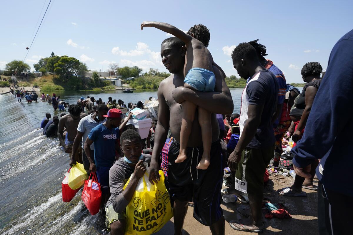 Haitian migrants use a dam to cross into the U.S.