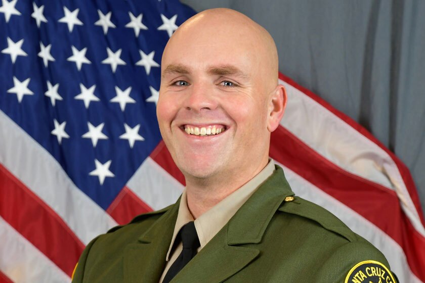 Santa Cruz County sheriff's Sgt. Damon Gutzwiller poses for a portrait in front of the U.S. flag