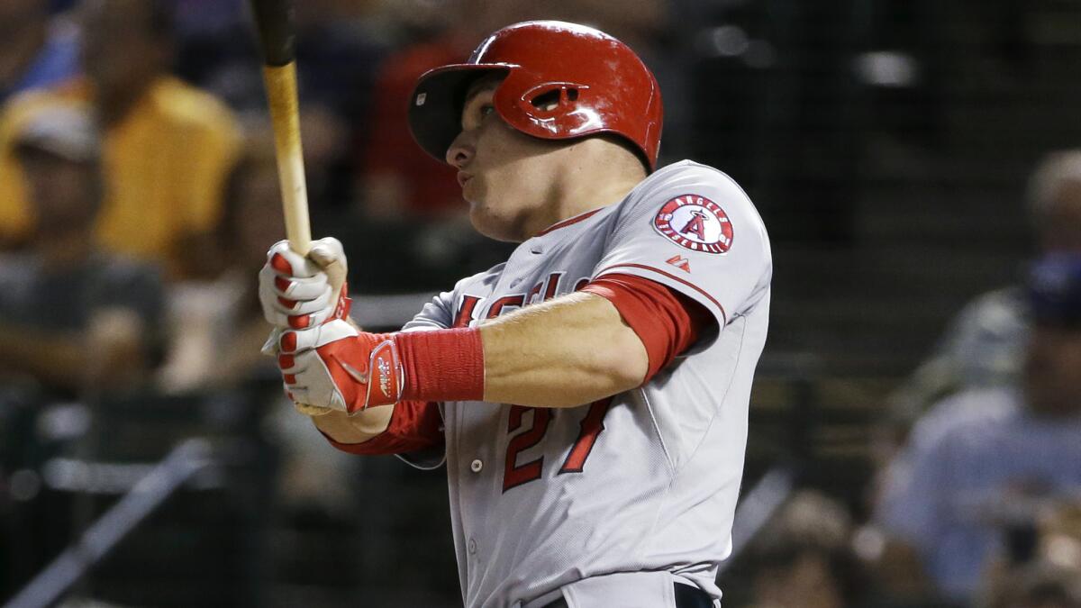 Angels center fielder Mike Trout follows through on a run-scoring triple in the eighth inning of a 9-3 win over the Texas Rangers on Tuesday.