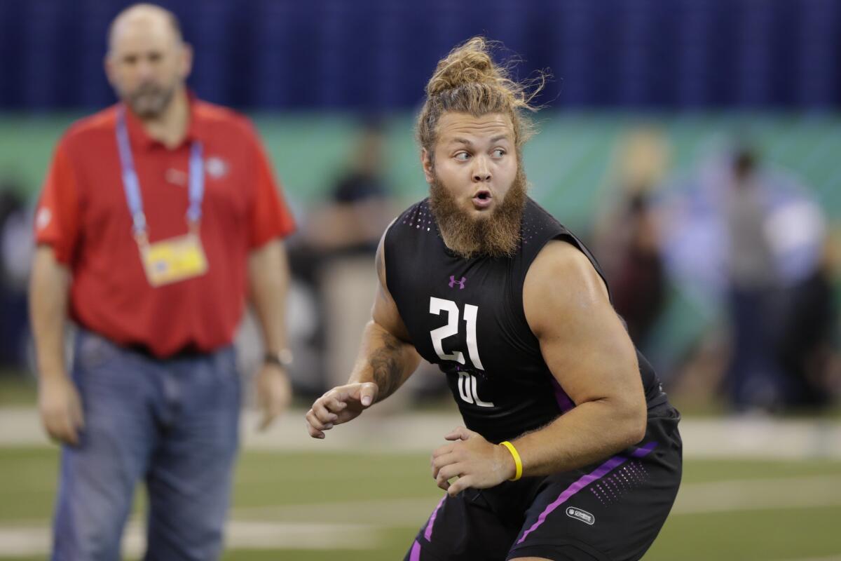 Cole Madison runs a drill at the NFL scouting combine.