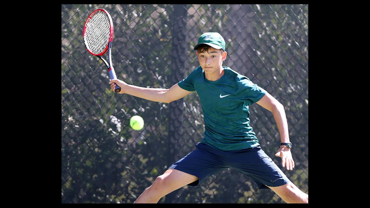 Sage Hill School singles tennis player Adam Hung stretches to return the ball against Northwood on Wednesday, April 18, 2018.
