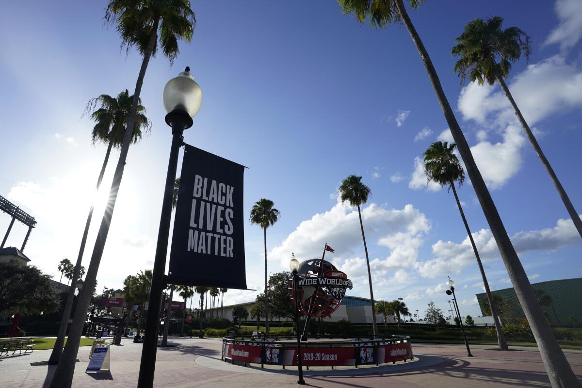 A Black Lives Matter banner hangs outside the arena in Lake Buena Vista, Fla., after a postponed NBA playoff game Wednesday.