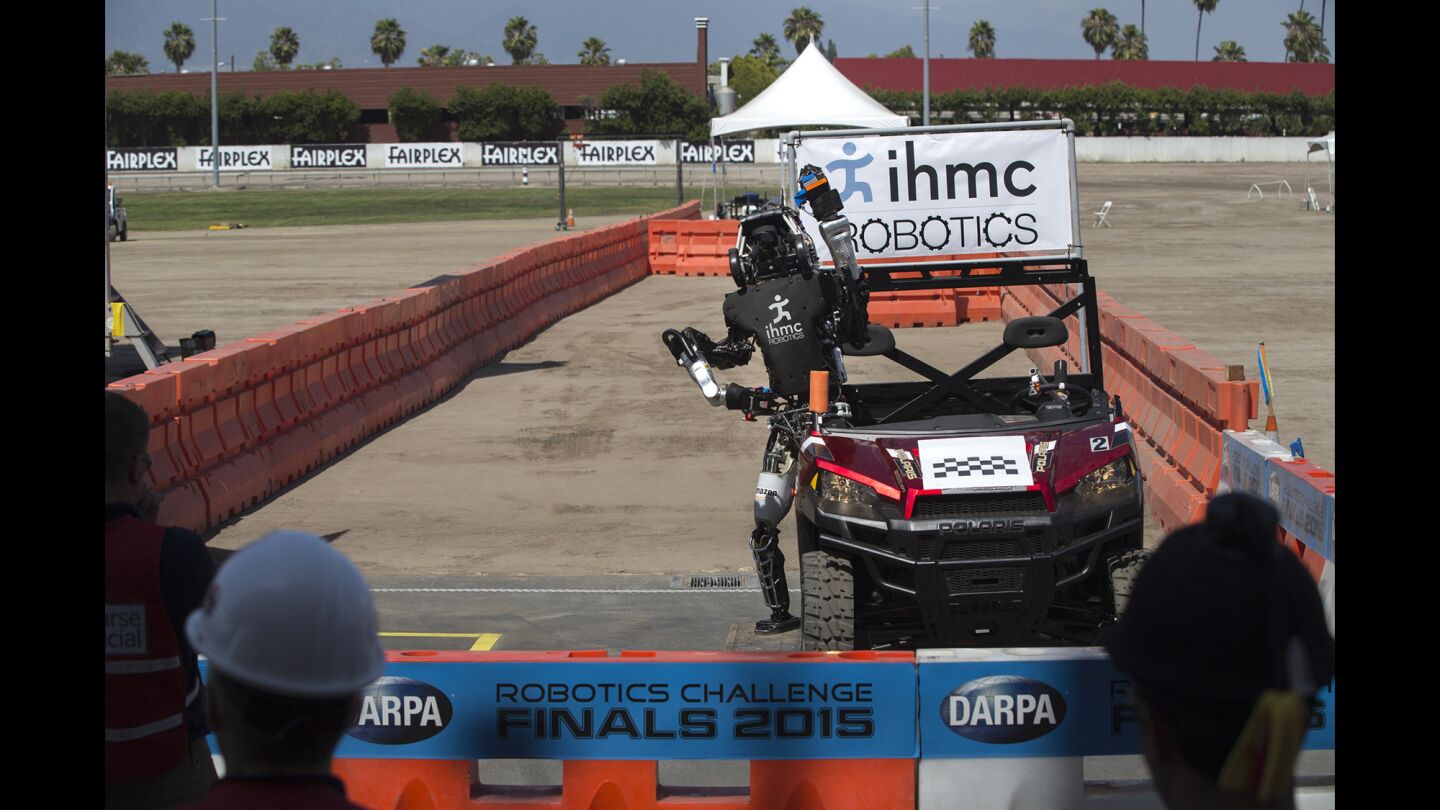 Running Man, built by Team IHMC Robotics in Florida, exits a vehicle successfully. The DARPA challenge required robots to be able to drive, but the hardest part was getting out of the car without falling.