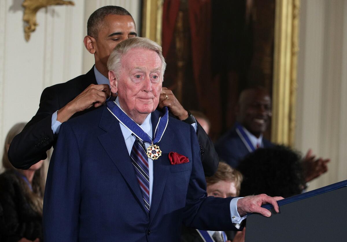 Vin Scully receives the Presidential Medal of Freedom from President Obama at the White House on Nov. 22, 2016.