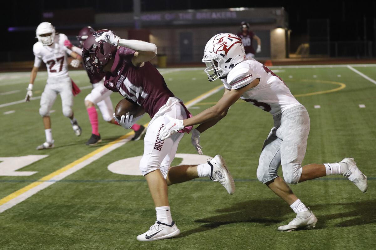 Jacob Diver of Laguna Beach shakes tackles toward the end zone for a touchdown against Ocean View on Friday.