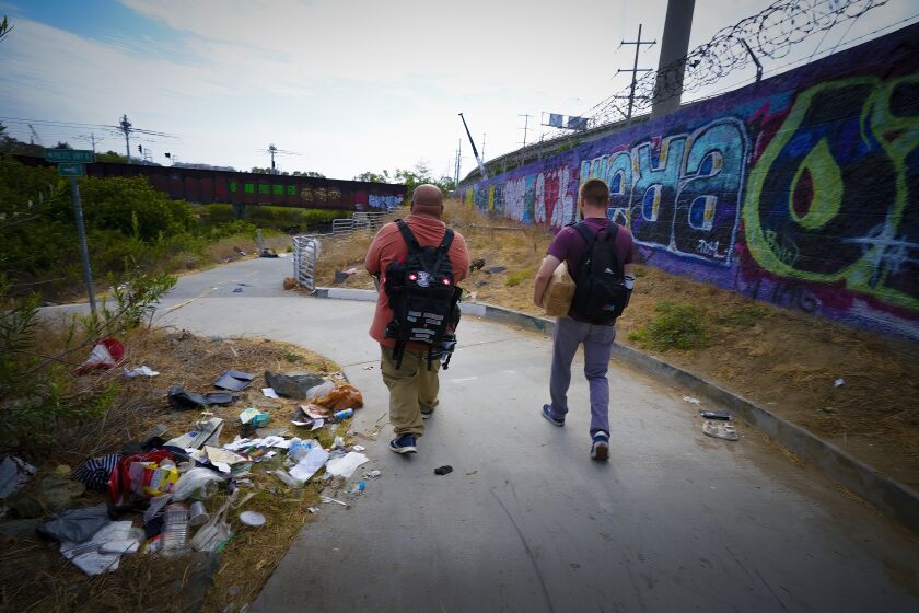 San Diego, CA - July 29: Near the San Diego Riverbed on Friday, July 29, 2022 in San Diego, CA., Alejandro Pulido (l), and Nate Dressel (r), Outreach Specialists from PATH San Diego head out to make contact with clients. (Nelvin C. Cepeda / The San Diego Union-Tribune)