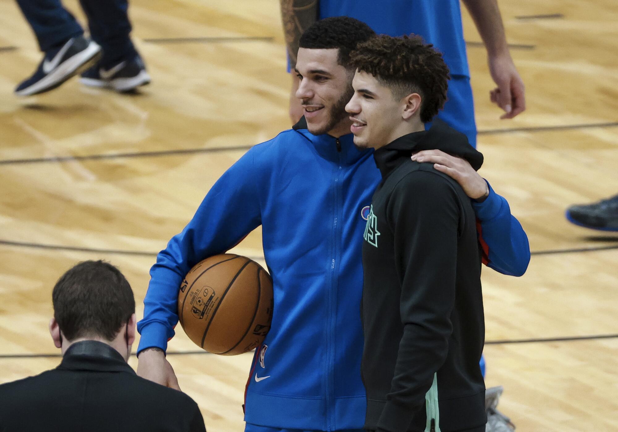 Lonzo, left, and LaMelo Ball pose for a photo before their first NBA game playing each other on Jan. 7, 2020.