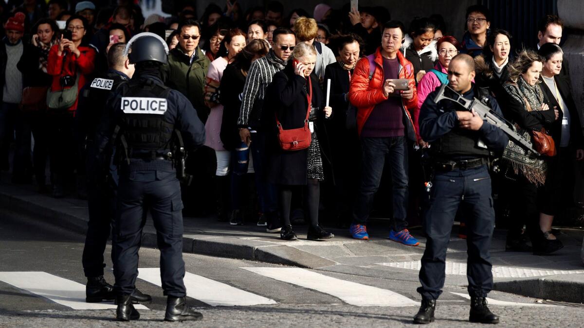 People are evacuated by police officers from the Pyramid of the Louvre Museum, close to the Carrousel du Louvre, where a French soldier opened fire after an attempted machete attack by a man allegedly shouting "Allahu Akbar," in Paris.