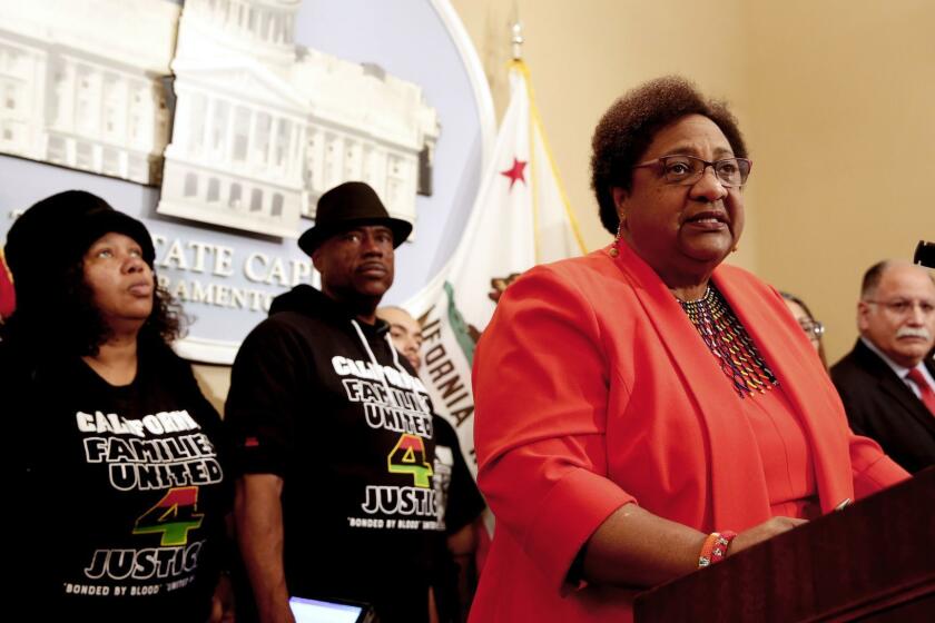 Assemblywoman Shirley Weber, D-San Diego, discusses her bill that would allow police to use deadly force only when there is no reasonable alternative, during a news conference, Wednesday, Feb. 6, 2019, in Sacramento, Calif. Weber's measure is one of two competing proposal over when police can use deadly force. Weber was accompanied by Beatrice Johnson, left and Cephus Johnson, center, the aunt and uncle of Oscar Grant who was killed by BART police n 2009. (AP Photo/Rich Pedroncelli)