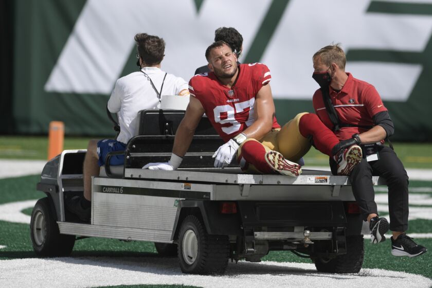 San Francisco 49ers defensive end Nick Bosa (97) is carted off the field after being injured during the first half of an NFL football game against the New York Jets Sunday, Sept. 20, 2020, in East Rutherford, N.J. (AP Photo/Bill Kostroun)