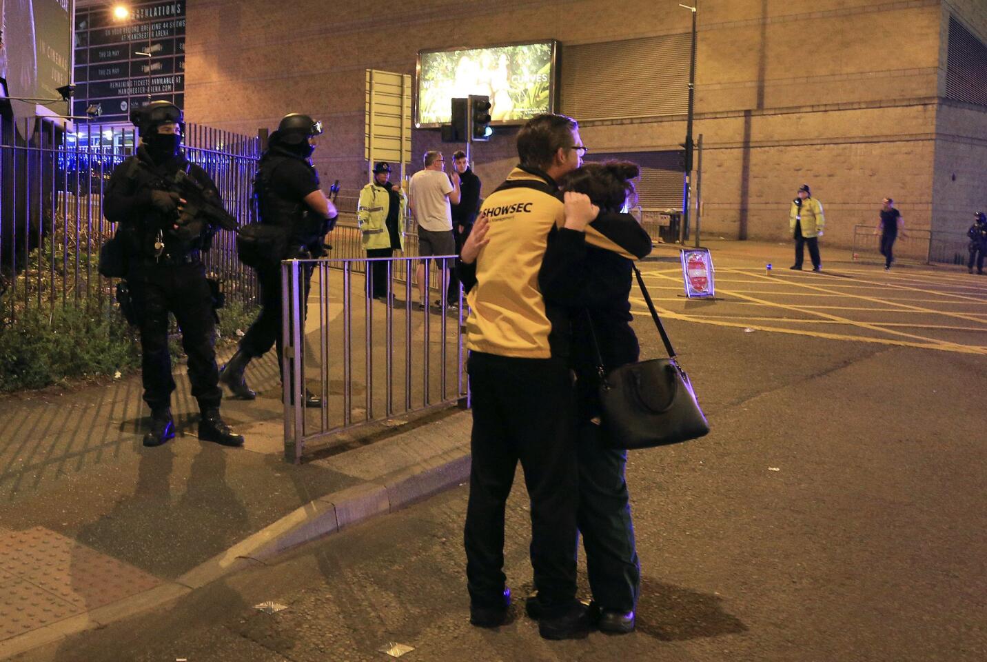 Armed police stand guard at Manchester Arena after reports of an explosion after an Ariana Grande concert.