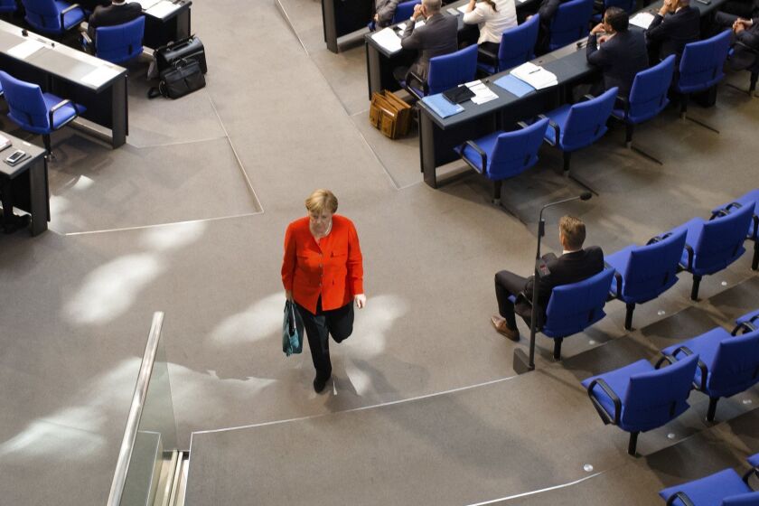 German Chancellor Angela Merkel leaves the plenary session of the German parliament Bundestag about the budget 2019, in Berlin, Germany, Wednesday, Sept. 12, 2018. (AP Photo/Markus Schreiber)