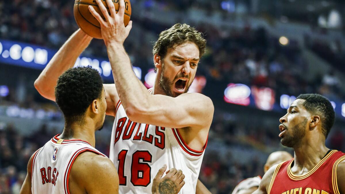 Chicago Bulls forward Pau Gasol, center, grabs a rebound in front of teammate Derrick Rose, left, and Cleveland Cavaliers forward Tristan Thompson during a game on Oct. 31.