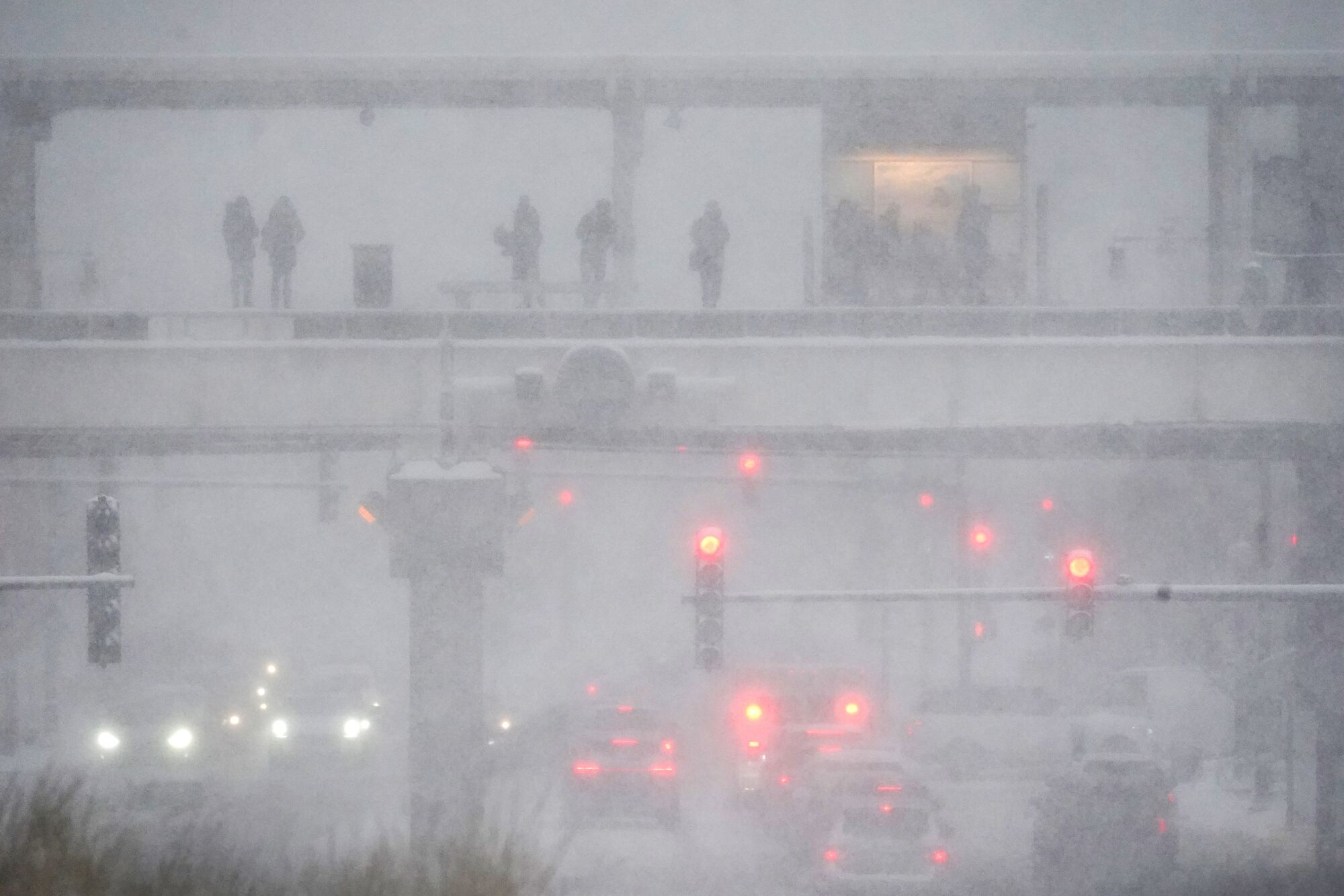 A street scene is obscured by heavy snow