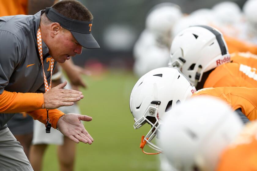 Volunteers Coach Butch Jones works with linemen during a practice on Tuesday in Knoxville, Tenn.