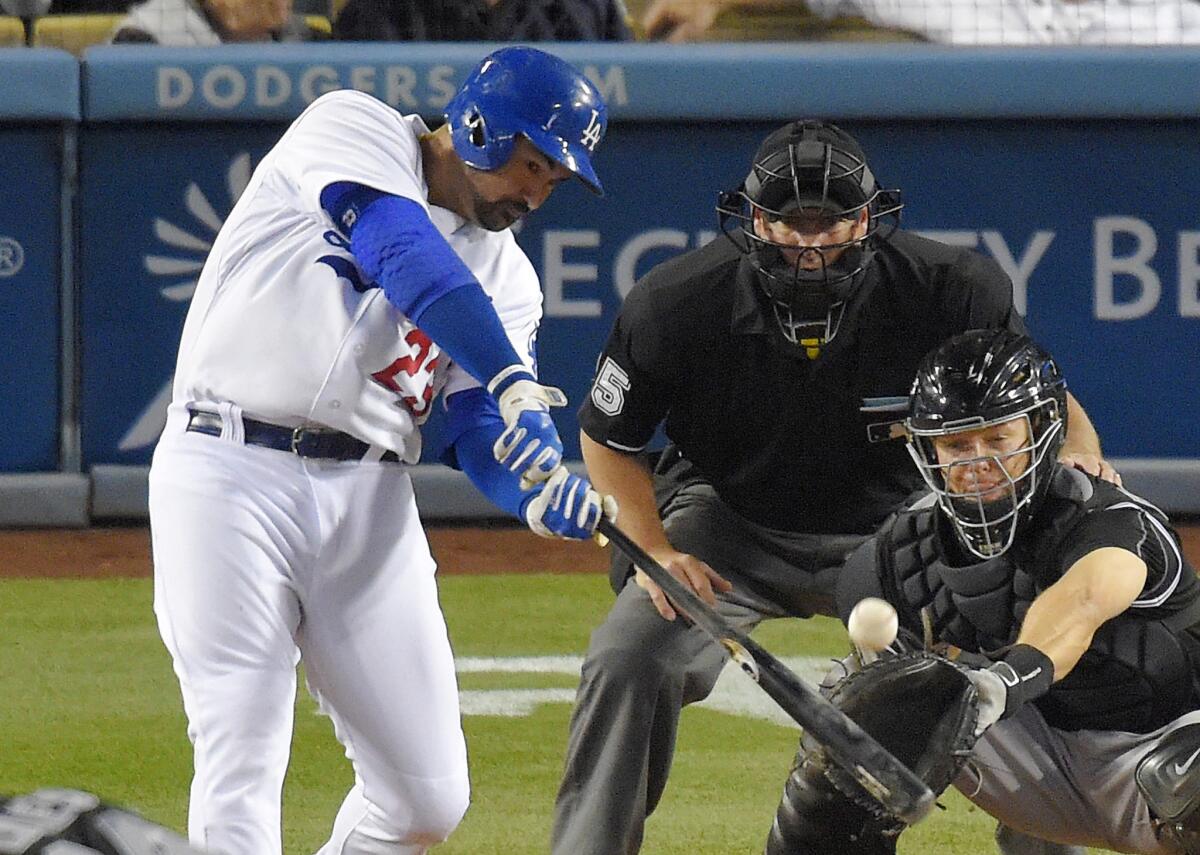 Dodgers first baseman Adrian Gonzalez drives in Joc Pederson and Jimmy Rollins with a two-run single in the fifth inning. The Dodgers beat the Rockies, 6-3.