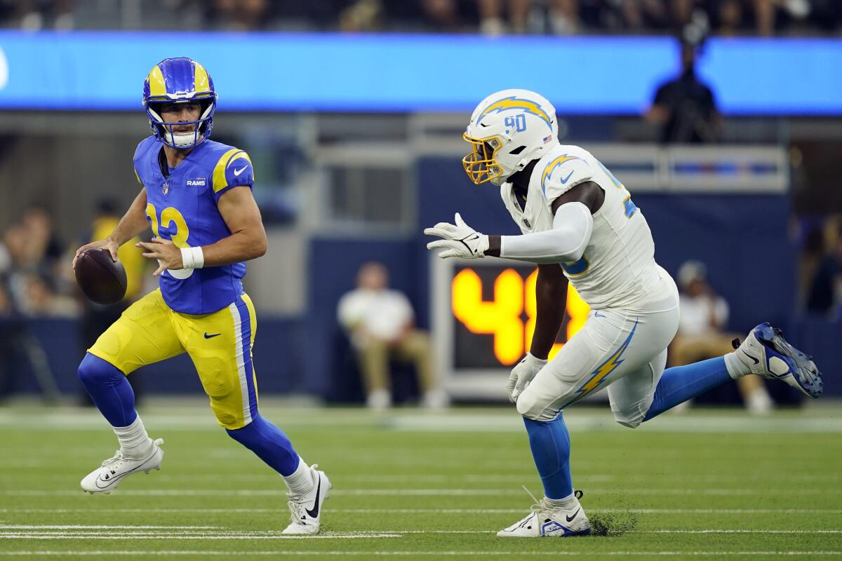 Chargers edge rusher Brevin Allen chases Rams quarterback Stetson Bennett.