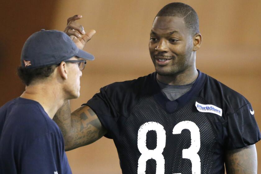 Chicago Bears tight end Martellus Bennett, right, speaks with Coach Marc Trestman during a minicamp practice in June. Bennett has been suspended indefinitely following an altercation in practice.
