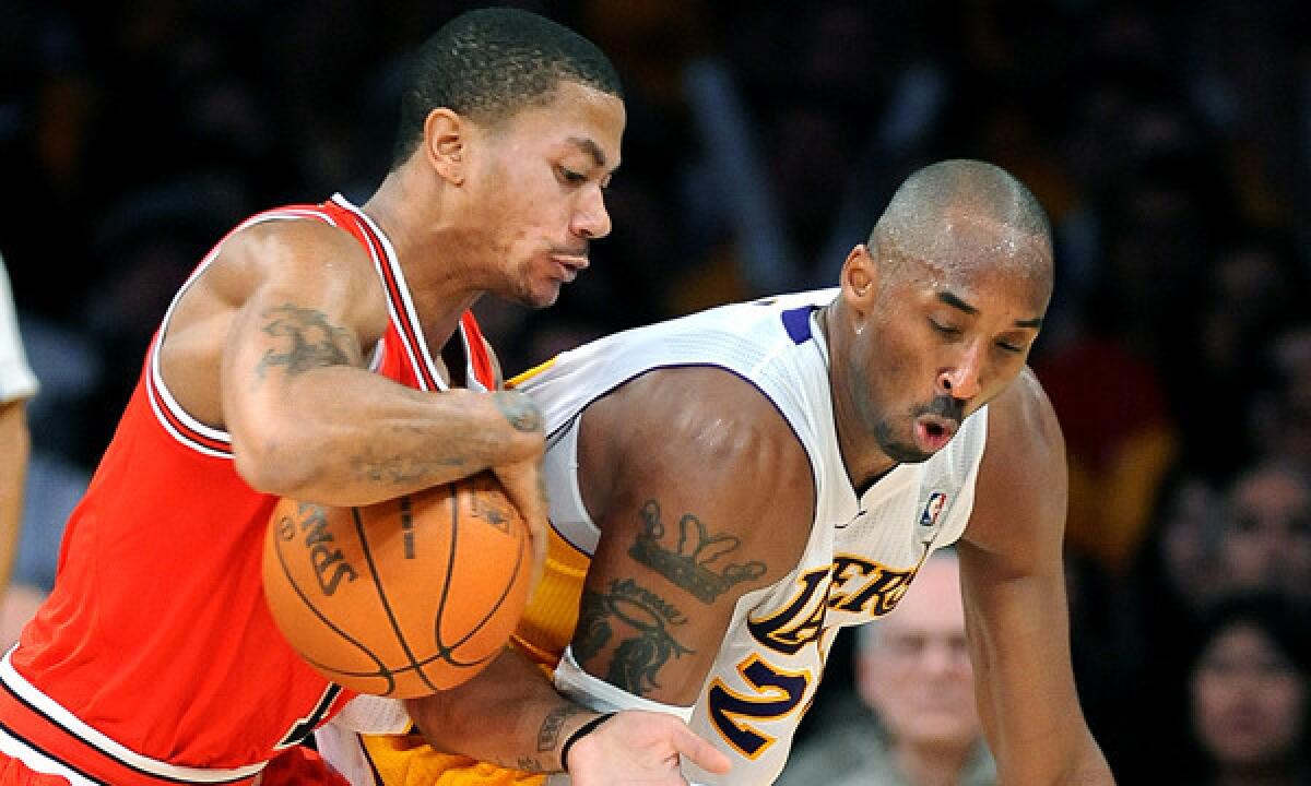 Chicago point guard Derrick Rose knocks the ball from Lakers guard Kobe Bryant at Staples Center.