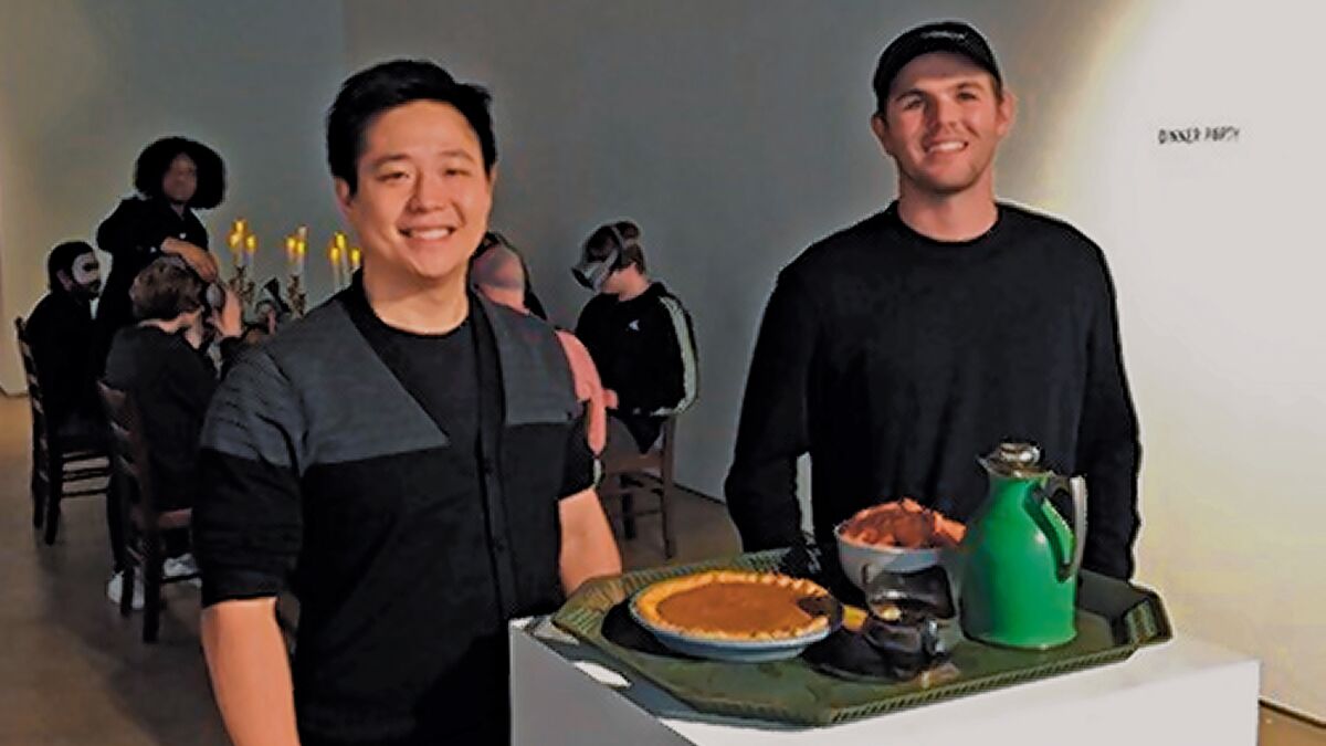 On opening day of the Virtual Reality Showcase, Wonderspaces president Jason Shin and general manager Jordan Hill pose at the entrance to the ‘Dinner Party’ experience by Angel Soto, Charlotte Stoudt and Laura Wexler. Wonderspaces Virtual Reality Showcase runs Nov. 30-Dec. 30, 2019 at San Diego Art Institute in Balboa Park, San Diego.