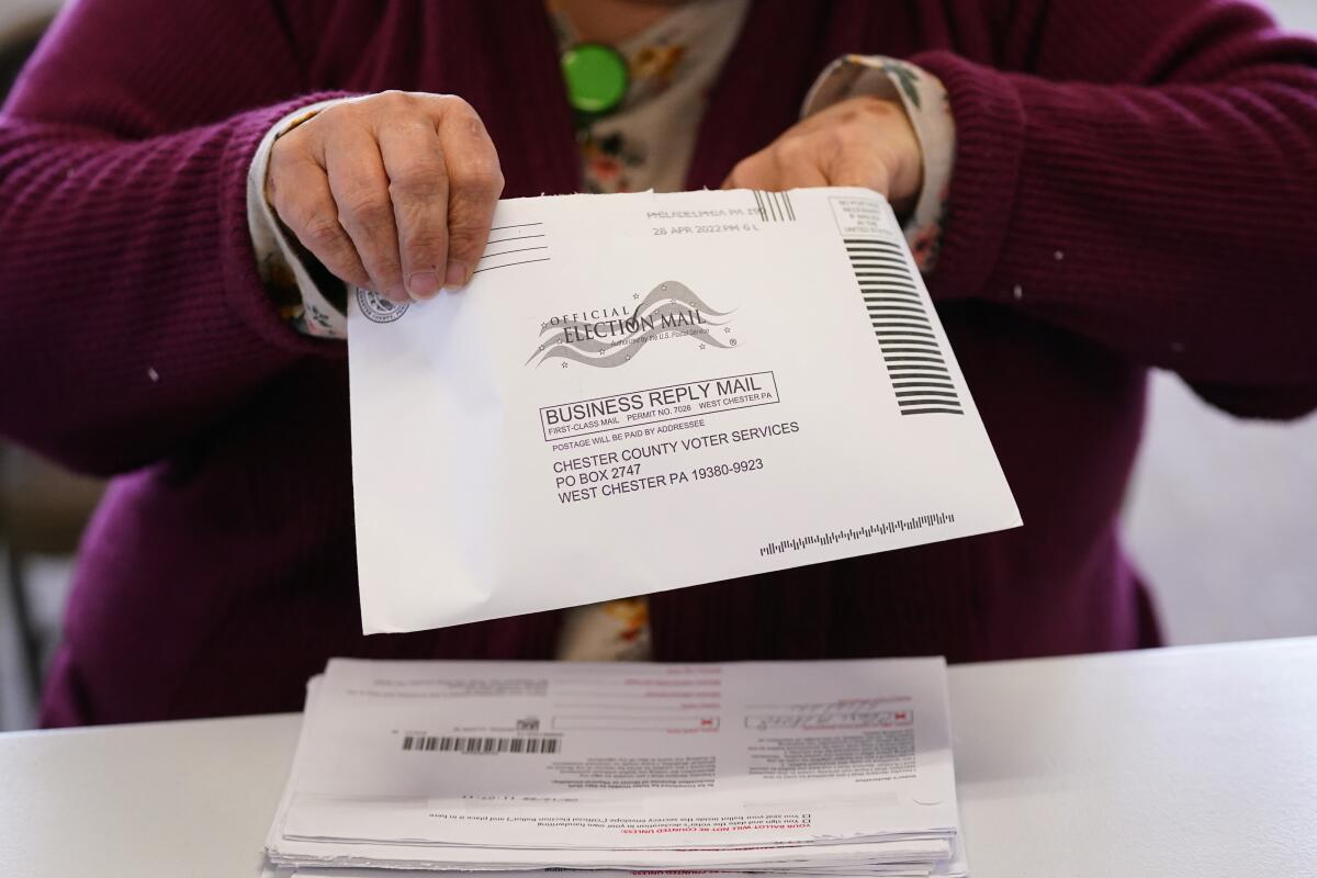 Election worker Monica Ging processes a ballot for the Pennsylvania primary election at the Chester County Voter Services office, Thursday, May 19, 2022, in West Chester, Pa. (AP Photo/Matt Slocum)