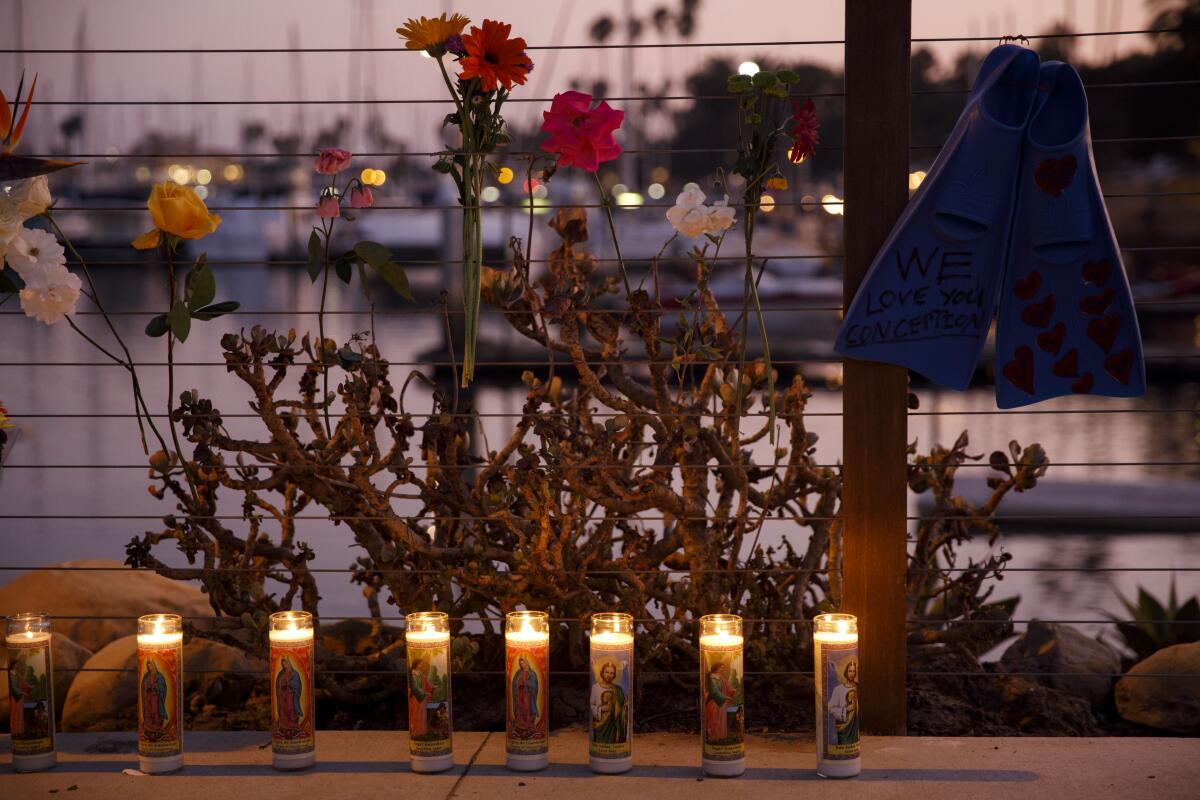 Candles at a makeshift memorial for the Conception boat fire