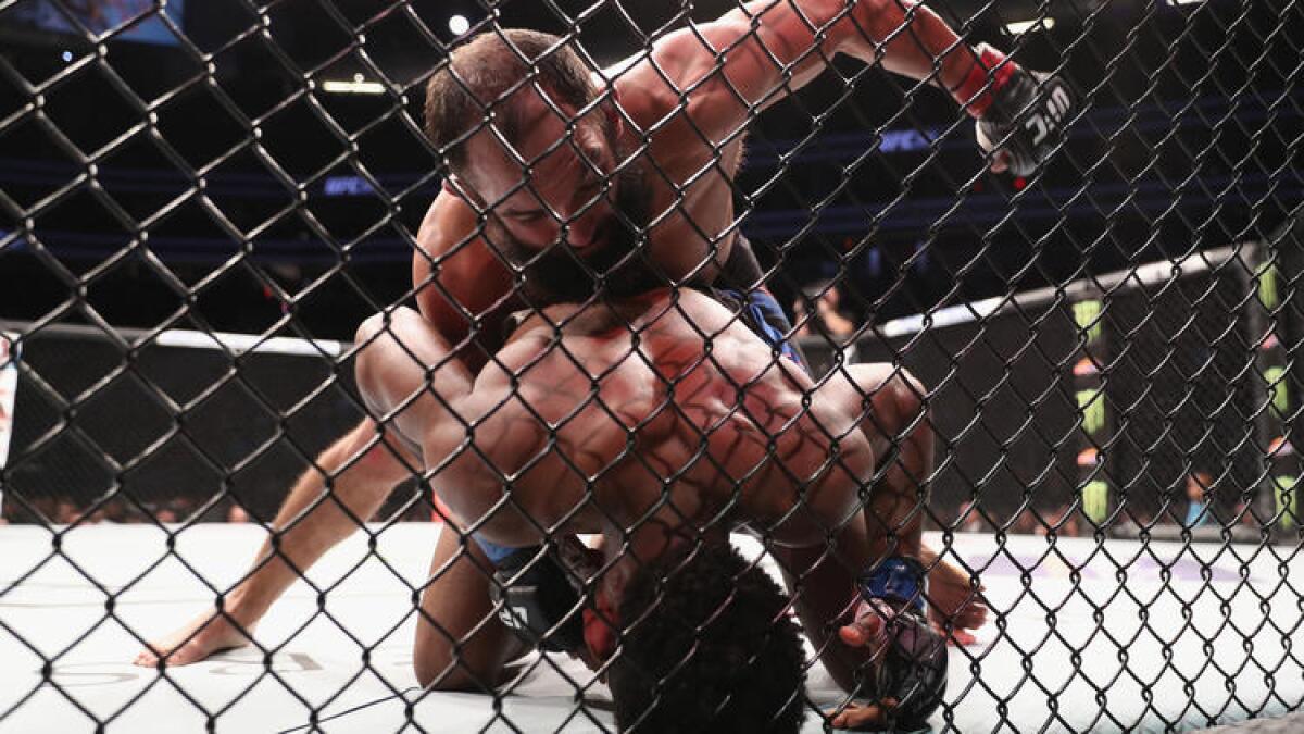 Johny Hendricks (top) punches Neil Magny during their welterweight bout at UFC 207.