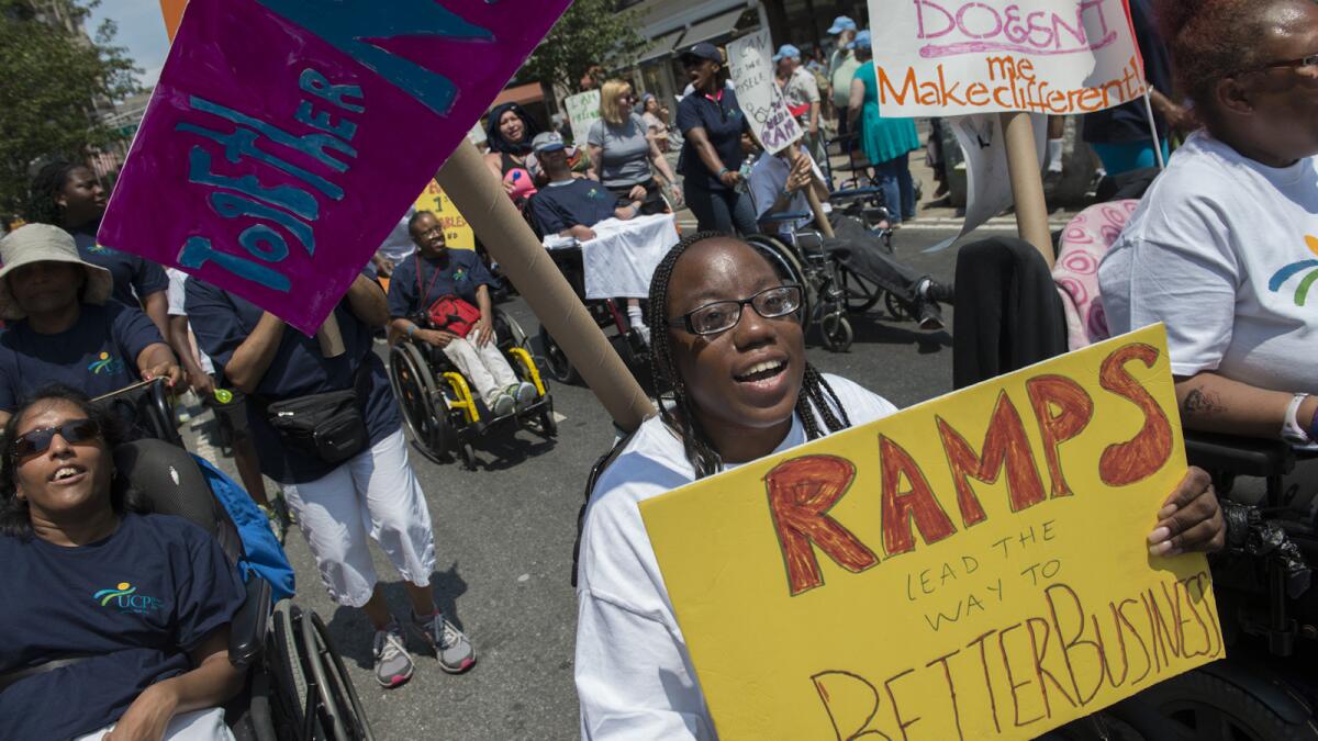 The inaugural Disability Pride Parade travels along Broadway in New York.