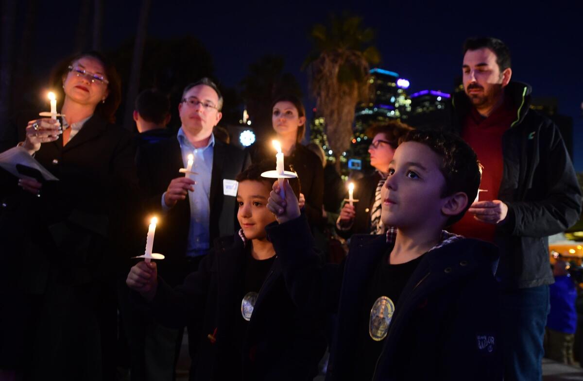 A crowd gathered outside Los Angeles City Hall Tuesday night to remember the victims of the recent attacks that devastated Paris.