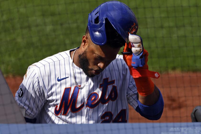 New York Mets' Robinson Cano reacts after striking out during the fourth inning of a baseball game.