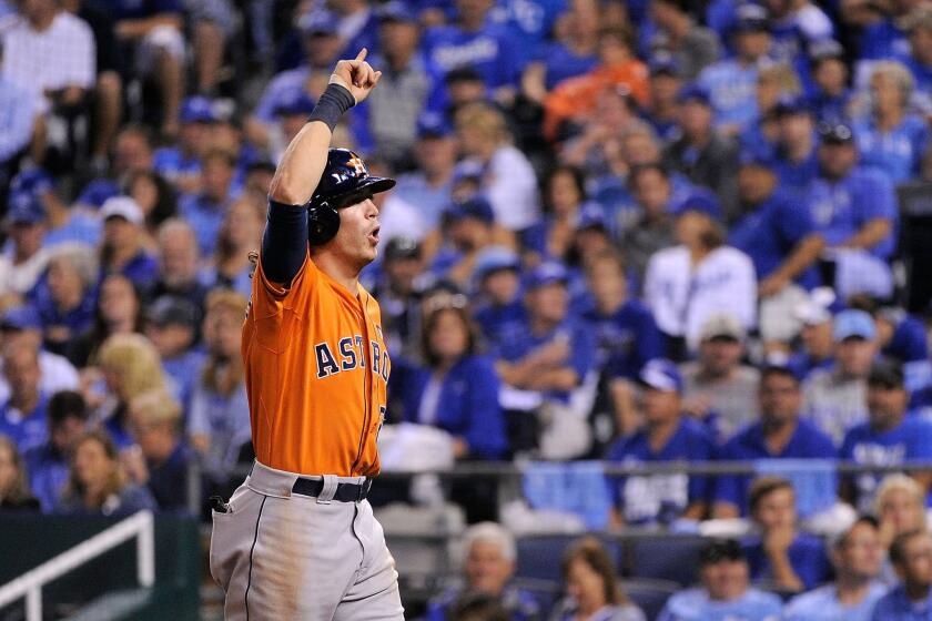 Colby Rasmus of the Houston Astros celebrates after hitting a solo home run in the eighth inning against the Kansas City Royals during Game 1 of the American League division series.